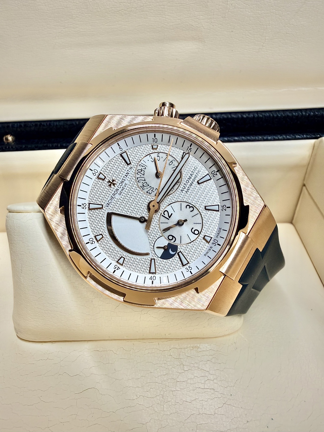 Close-up of the rose-gold Vacheron Constantin Overseas Dual Time with a silver textured dial, resting in its presentation box
